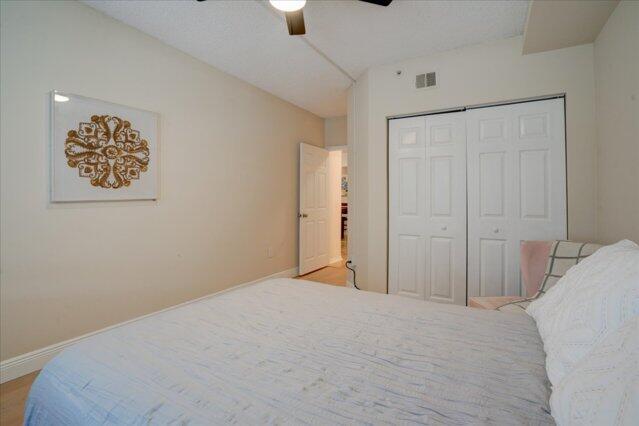 2221 Tuscany Way, Boynton Beach, FL 33435 - bedroom with a closet, baseboards, ceiling fan, and visible vents