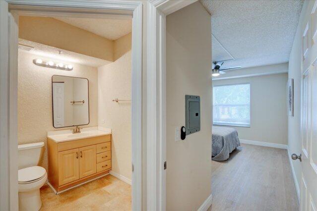 2221 Tuscany Way, Boynton Beach, FL 33435 - bathroom featuring enclosed tub / shower combo, a textured wall, visible vents, toilet, and vanity