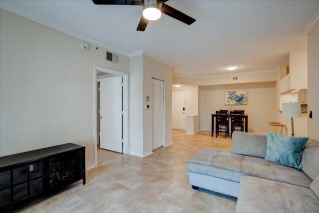 2221 Tuscany Way, Boynton Beach, FL 33435 - living area with ceiling fan, baseboards, visible vents, and ornamental molding