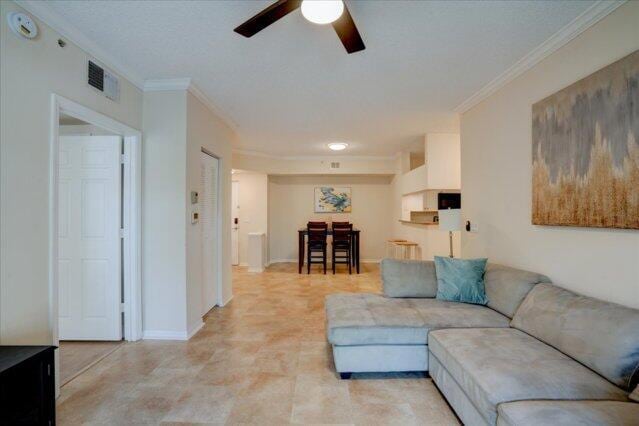 2221 Tuscany Way, Boynton Beach, FL 33435 - living room featuring ceiling fan and crown molding