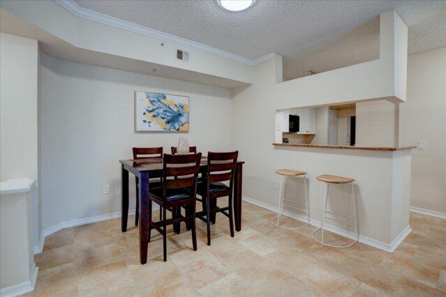2221 Tuscany Way, Boynton Beach, FL 33435 - living area featuring crown molding, a textured ceiling, and a ceiling fan