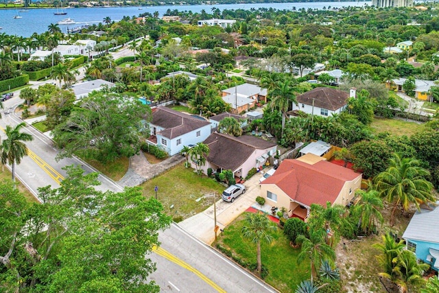 birds eye view of property with a water view and a residential view