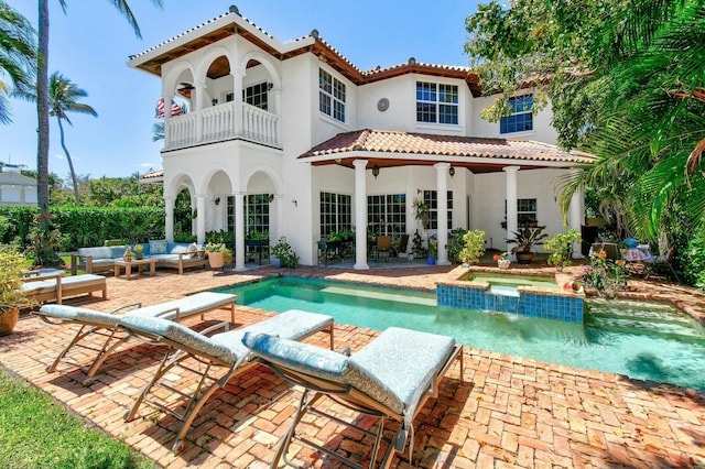 201 Avila Rd, West Palm Beach, FL 33405 - back of house with a balcony, an outdoor living space, a patio area, and stucco siding