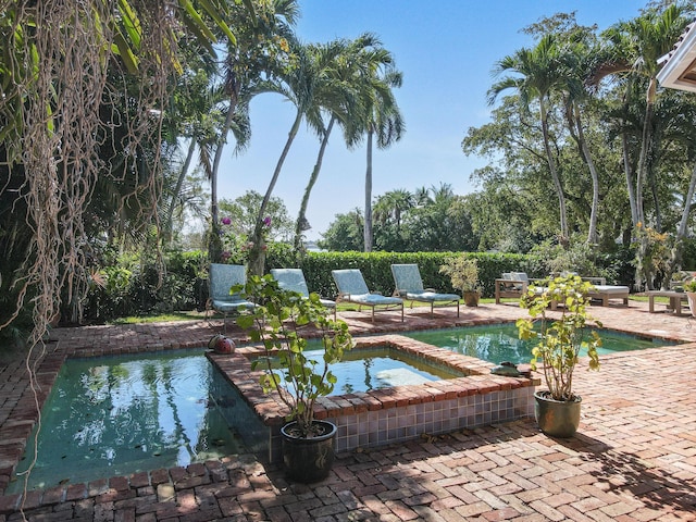 201 Avila Rd, West Palm Beach, FL 33405 - view of swimming pool with an outdoor hot tub and a patio