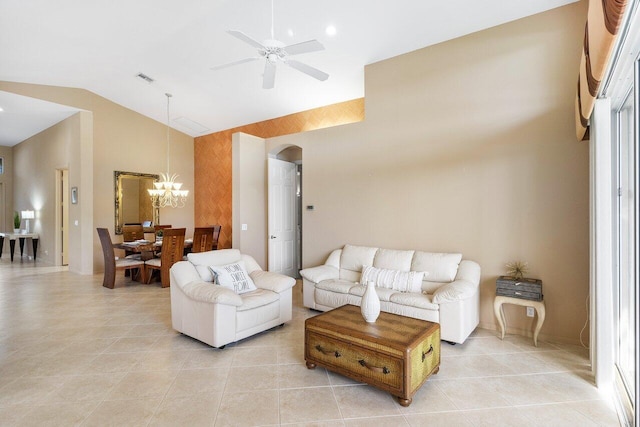 living area featuring arched walkways, visible vents, ceiling fan with notable chandelier, high vaulted ceiling, and light tile patterned floors