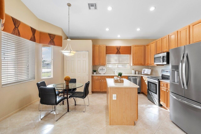 kitchen with stainless steel appliances, visible vents, recessed lighting, light countertops, and a kitchen island