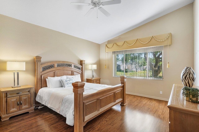 bedroom featuring lofted ceiling, a ceiling fan, dark wood-type flooring, and baseboards