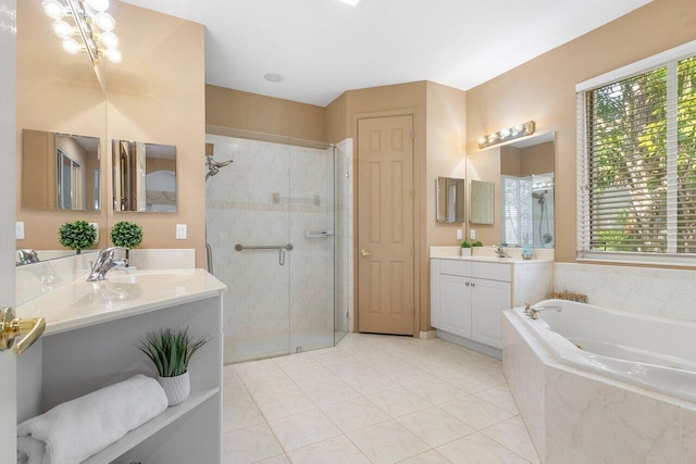 full bathroom featuring a bath, vanity, tile patterned floors, and a stall shower