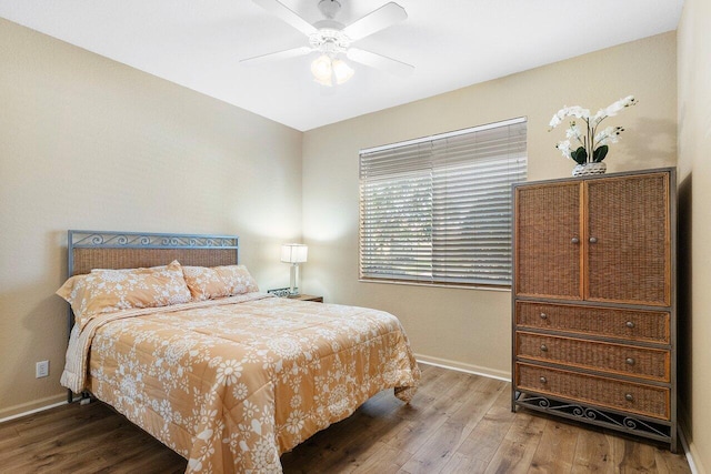 bedroom featuring hardwood / wood-style flooring, ceiling fan, and baseboards