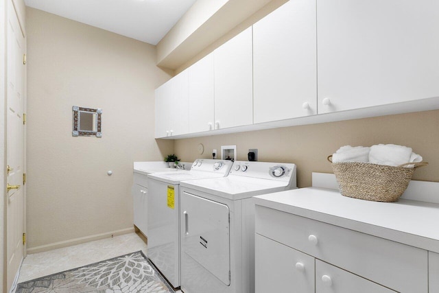 clothes washing area featuring baseboards, cabinet space, light tile patterned flooring, and independent washer and dryer