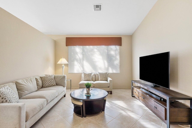 living room featuring light tile patterned flooring and visible vents