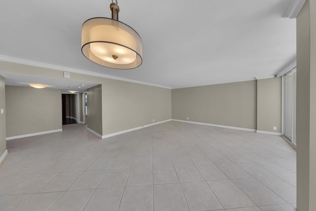 empty room featuring crown molding, baseboards, and light tile patterned floors