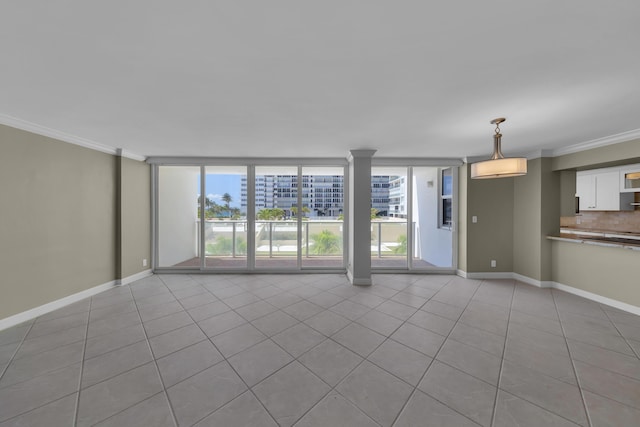unfurnished living room featuring tile patterned flooring, crown molding, and baseboards