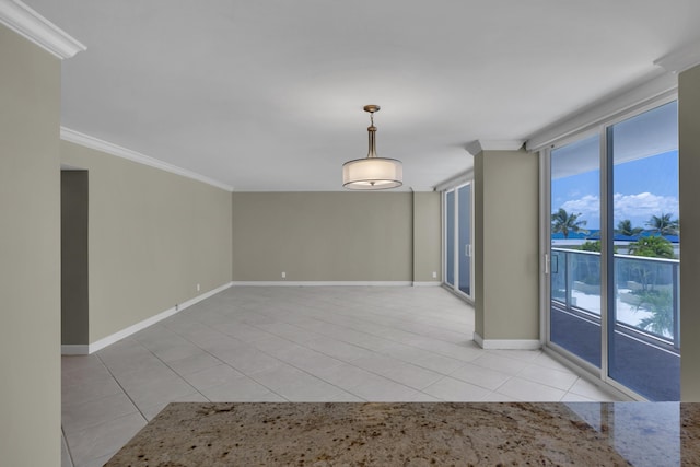 unfurnished room with light tile patterned flooring, crown molding, and baseboards
