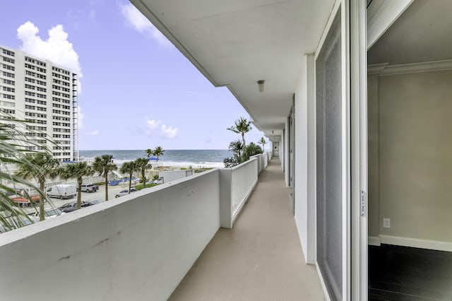 balcony with view of water and beach