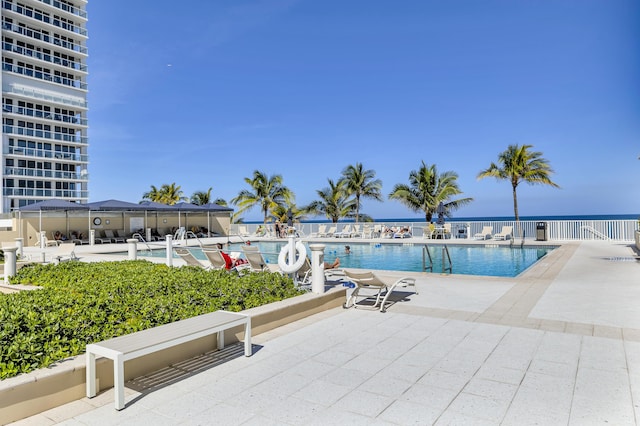 community pool featuring a patio and fence