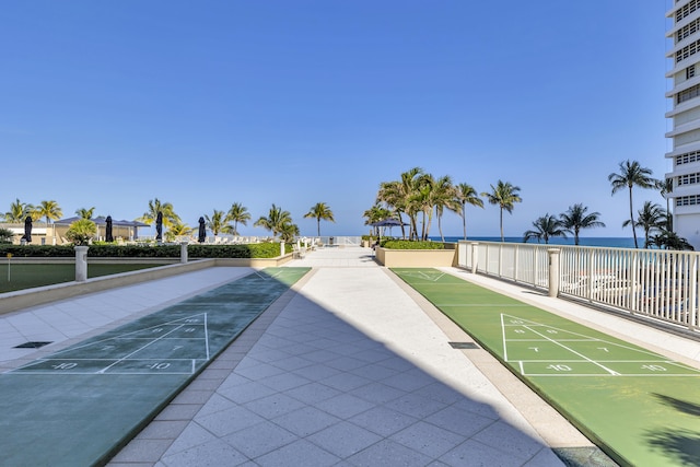 view of home's community featuring shuffleboard and a water view