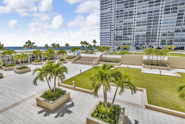 view of community featuring a lawn and a water view