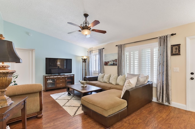 living area featuring wood finished floors, ceiling fan, vaulted ceiling, and a textured ceiling