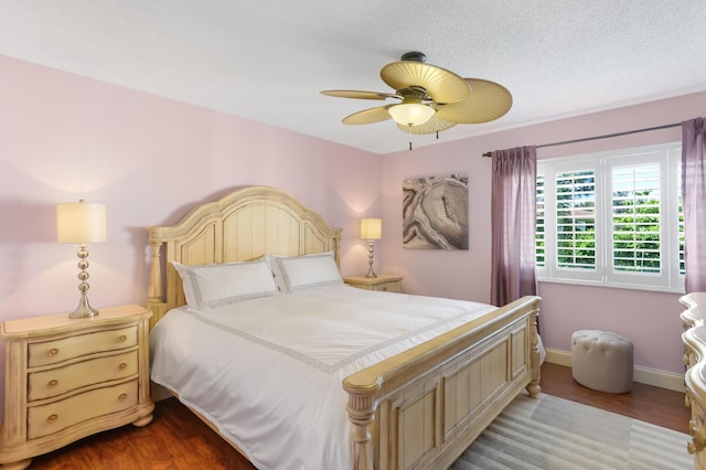 bedroom with wood finished floors, a ceiling fan, and baseboards