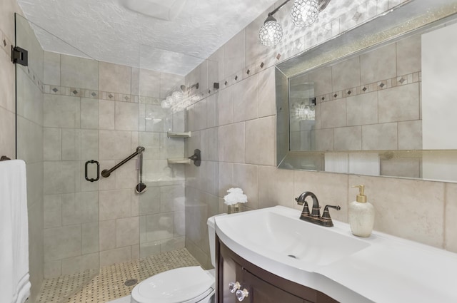 bathroom with a shower stall, toilet, tile walls, vanity, and backsplash