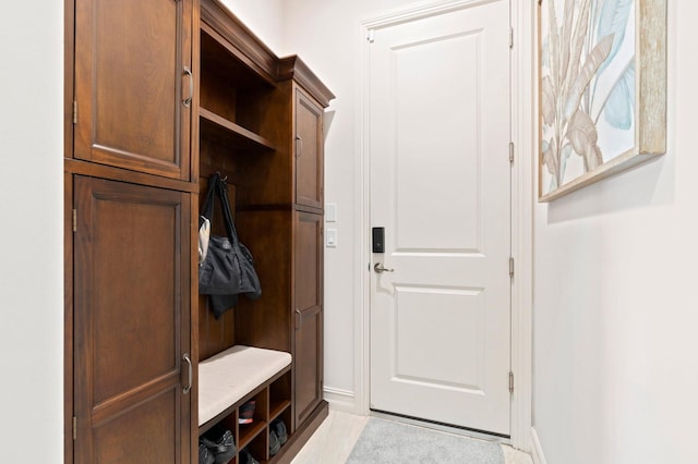 mudroom featuring baseboards and light tile patterned flooring