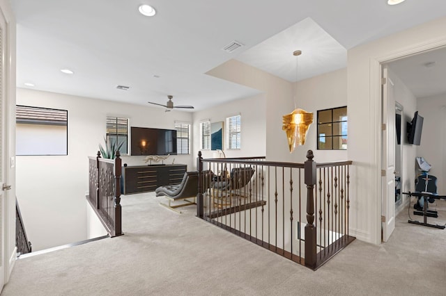 hall featuring carpet flooring, an upstairs landing, and recessed lighting