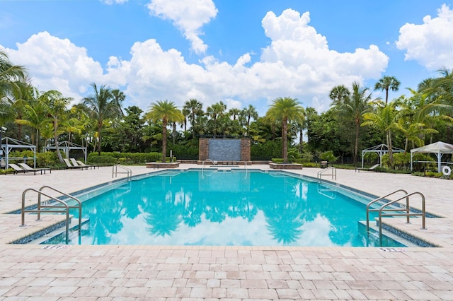 community pool featuring a gazebo and a patio area