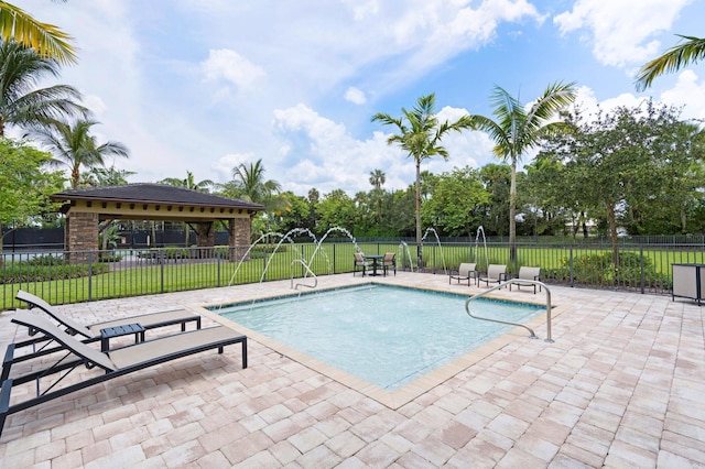 view of pool featuring a gazebo, a lawn, fence, a patio, and a fenced in pool