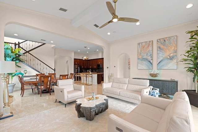 living room featuring visible vents, arched walkways, stairs, and crown molding