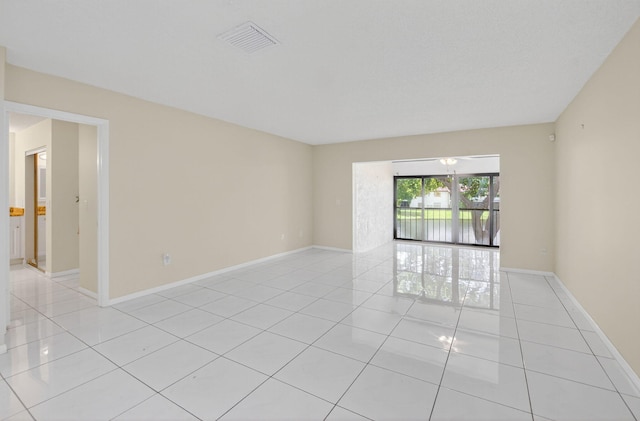 21839 Arriba Real Unit 10-D, Boca Raton, FL 33433 - spare room featuring light tile patterned floors and baseboards