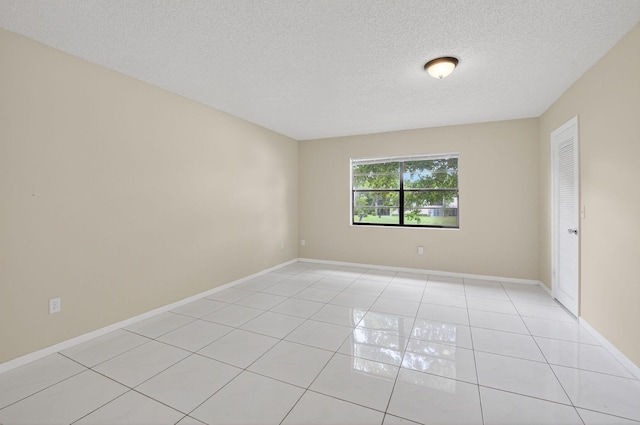 21839 Arriba Real Unit 10-D, Boca Raton, FL 33433 - empty room with light tile patterned flooring and a textured ceiling