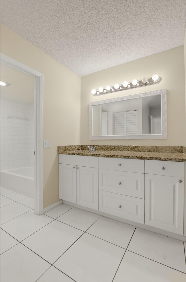 21839 Arriba Real Unit 10-D, Boca Raton, FL 33433 - bathroom featuring tile patterned flooring, vanity, a textured ceiling, and tub / shower combination