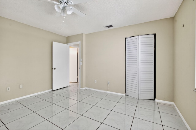 21839 Arriba Real Unit 10-D, Boca Raton, FL 33433 - unfurnished bedroom with a closet, a textured ceiling, ceiling fan, and light tile patterned flooring