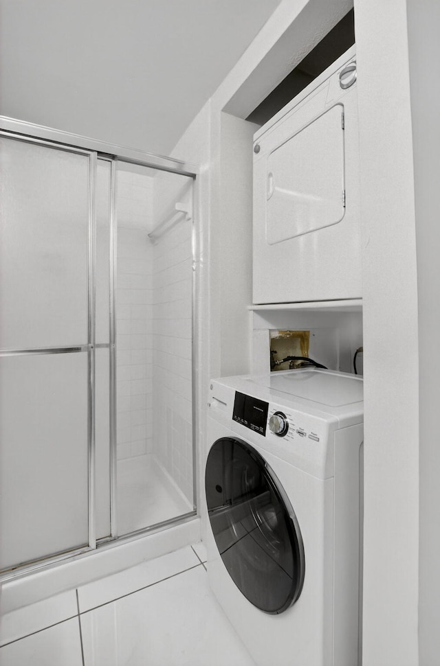 21839 Arriba Real Unit 10-D, Boca Raton, FL 33433 - laundry area with stacked washing machine and dryer and tile patterned floors