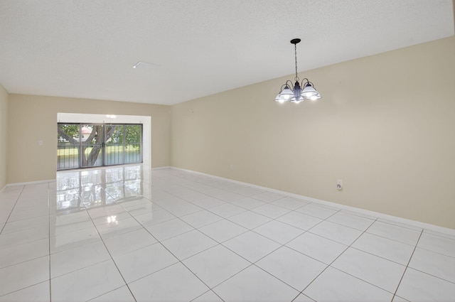 21839 Arriba Real Unit 10-D, Boca Raton, FL 33433 - empty room featuring a chandelier and light tile patterned flooring