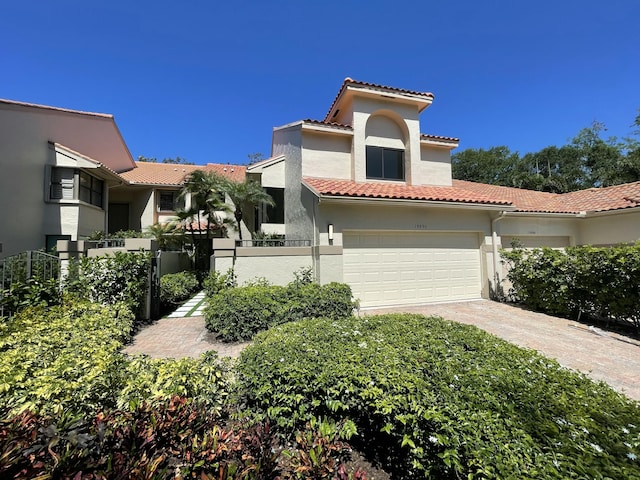 13890 Parc Dr, Palm Beach Gardens, FL 33410 - mediterranean / spanish-style home with stucco siding, concrete driveway, and a tile roof