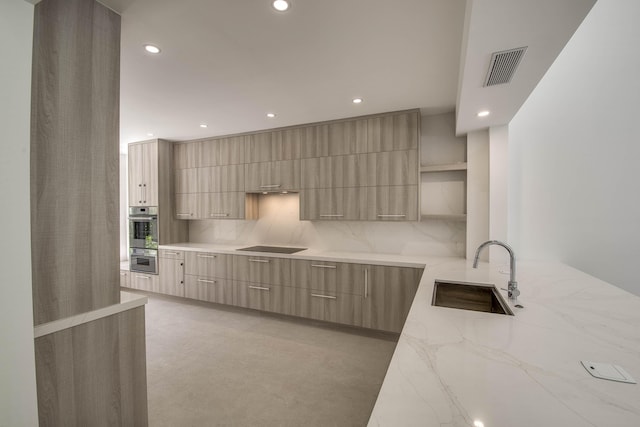 13890 Parc Dr, Palm Beach Gardens, FL 33410 - kitchen featuring modern cabinets, a sink, light stone counters, backsplash, and recessed lighting