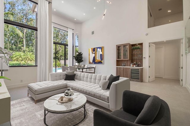 13890 Parc Dr, Palm Beach Gardens, FL 33410 - living area featuring beverage cooler, baseboards, a towering ceiling, and recessed lighting