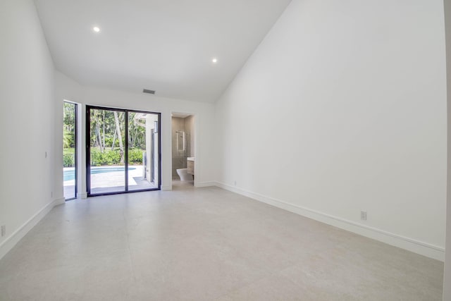 13890 Parc Dr, Palm Beach Gardens, FL 33410 - spare room with baseboards, recessed lighting, finished concrete flooring, and high vaulted ceiling
