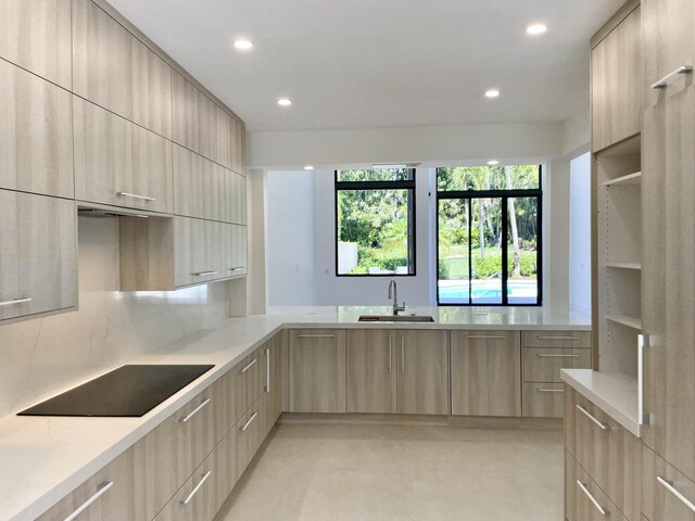 13890 Parc Dr, Palm Beach Gardens, FL 33410 - kitchen featuring modern cabinets, light brown cabinetry, black electric cooktop, a sink, and recessed lighting