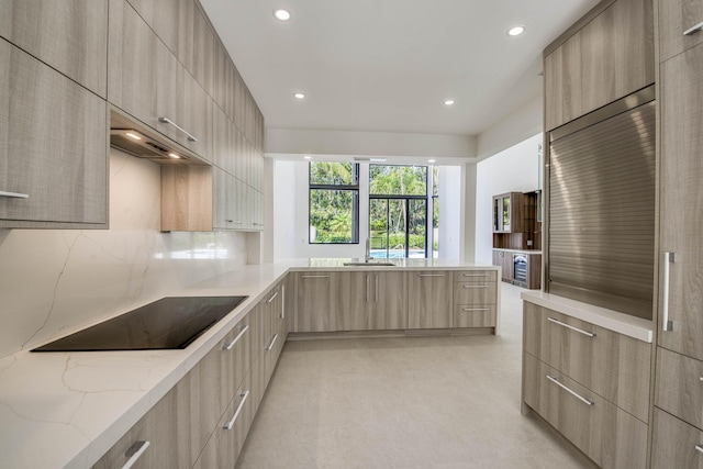 13890 Parc Dr, Palm Beach Gardens, FL 33410 - kitchen featuring modern cabinets, light brown cabinets, recessed lighting, black electric cooktop, and light stone counters