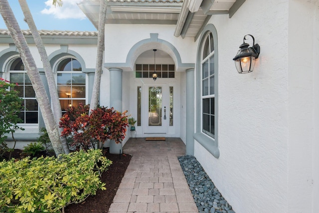 doorway to property featuring stucco siding
