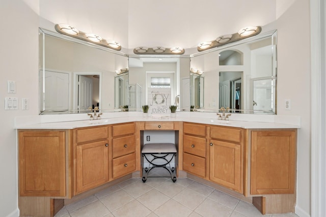 bathroom featuring tile patterned flooring, double vanity, and a sink