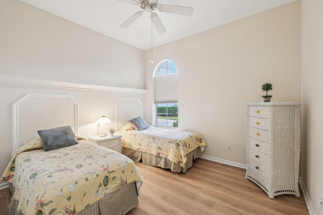 bedroom featuring wood finished floors, ceiling fan, and baseboards
