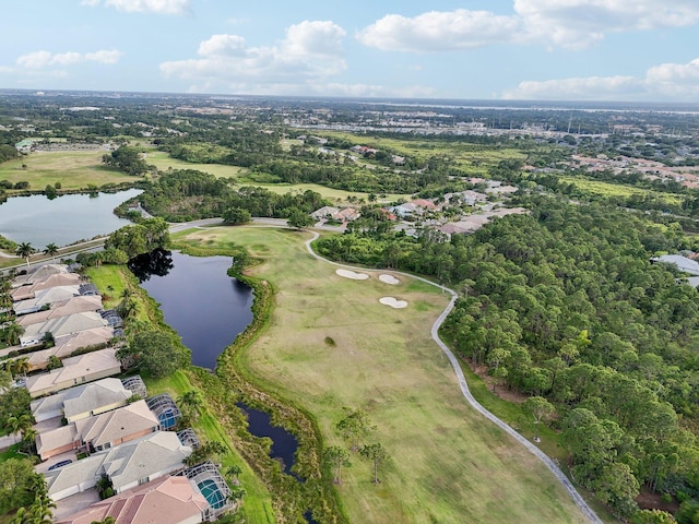 drone / aerial view with golf course view, a residential view, and a water view