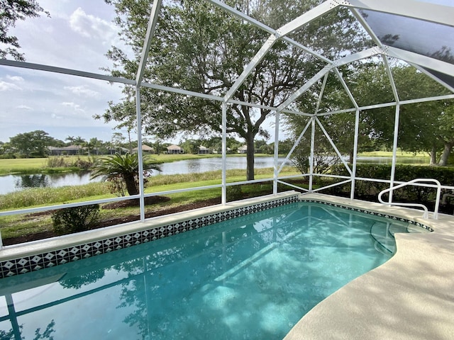 outdoor pool with a water view and a lanai