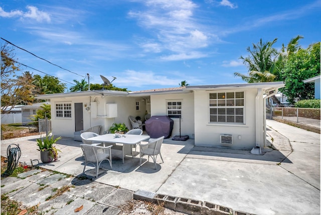 391 SW 2nd St, Boca Raton, FL 33432 - rear view of property with a patio, stucco siding, and fence