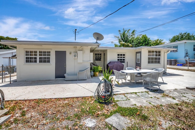 391 SW 2nd St, Boca Raton, FL 33432 - back of house with a patio, stucco siding, and fence