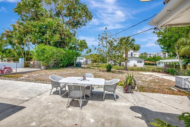 391 SW 2nd St, Boca Raton, FL 33432 - view of patio with a fenced backyard and outdoor dining space